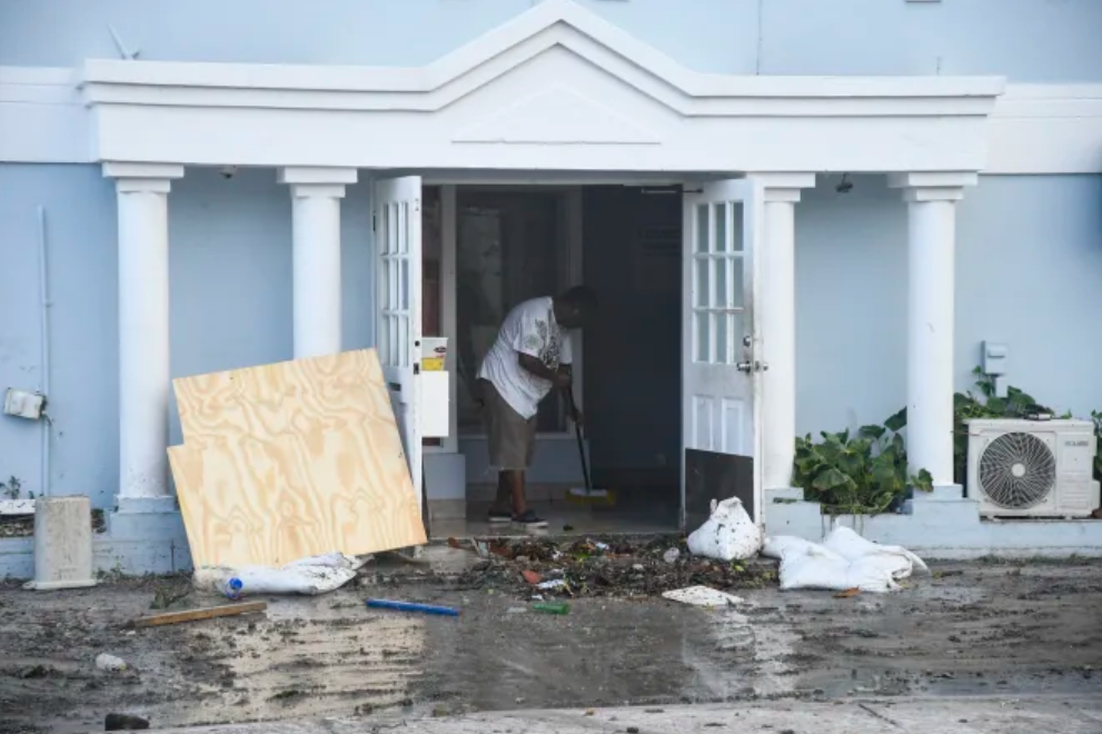 photo:A man clears water from a damaged restaurant in Hastings, Barbados, on July 1.